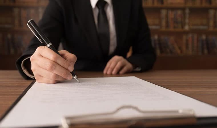 Lawyer Signing Legal Documents — Dispute Resolution in Port Macquarie, NSW